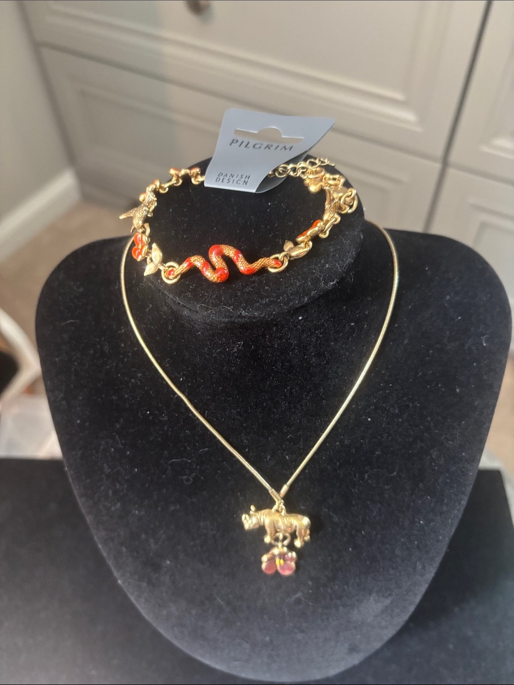 Pilgrim Goldtone Rhino necklace with a snake and flower bracelet.